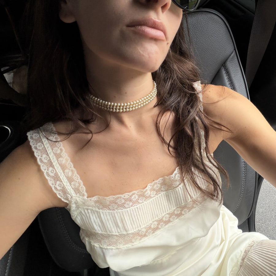 julia in a white lace top and pearls